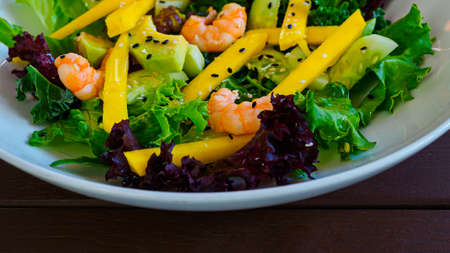 diet salad with shrimp, mango, avocado, cucumber, black sesame seeds and lettuceの写真素材
