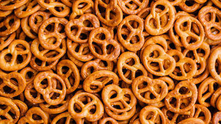 food background: lots of crispy pretzels with saltの写真素材