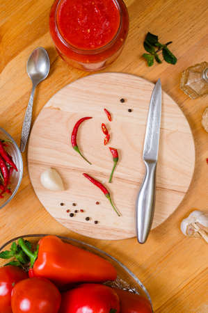 ingredients for making a traditional Georgian hot red sauce - adjika on a wooden table, close-up, flatleyの写真素材