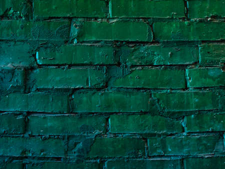 texture: old cracked brick wall painted in green paintの写真素材