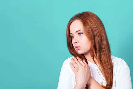 young attractive redhead girl sadly looks away. Studio shotの写真素材