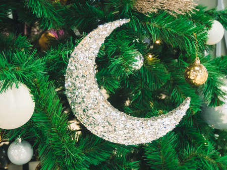 big shiny crescent on the tree - christmas decoration close-up