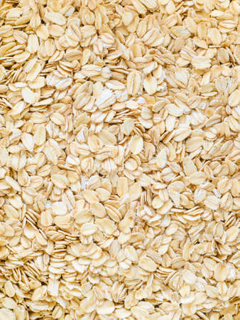 uncooked oatmeal close up - background, healthy foodの写真素材