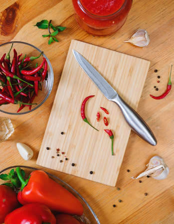 chili peppers on a cutting board - hot sauce making processの写真素材