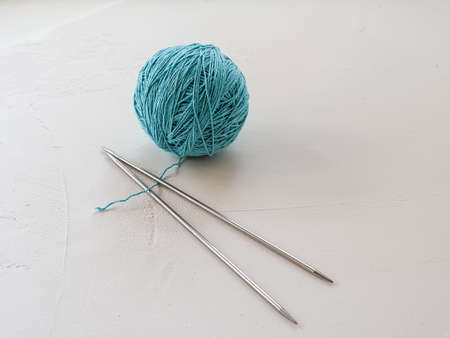 cotton thin thread and knitting needles for knitting on a white backgroundの写真素材