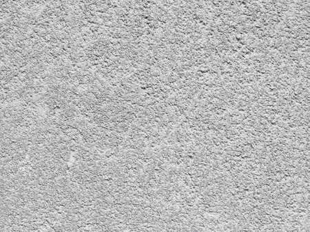 part of a relief concrete wall with spots - old building, surface textureの写真素材