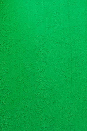 plastered wall with the addition of green color close-up, embossed surfaceの写真素材