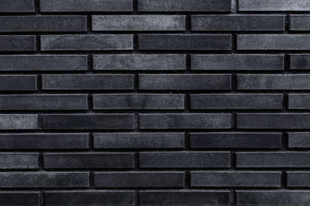 dark gray brick wall close up - textureの写真素材