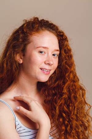 Portrait of a beautiful smiling girl without makeup, no skin retouching. Teen skin care concept. Shot in a studioの写真素材