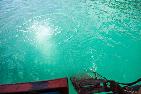 diver plunged into sea water from a boatの写真素材