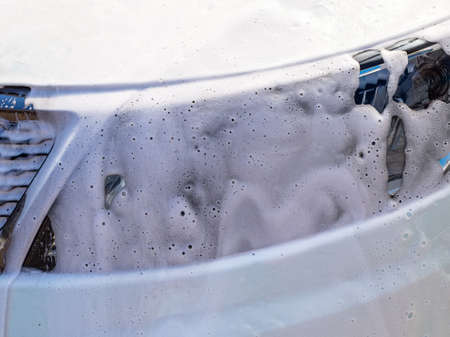foam on headlight at car wash close upの写真素材