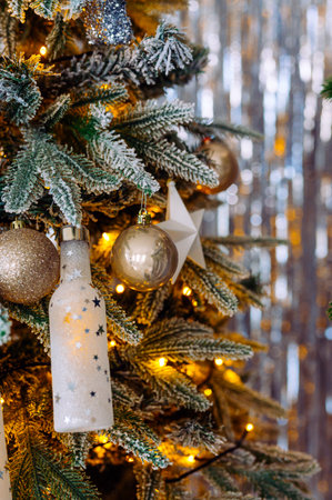 christmas tree with golden and white toys and garland close upの写真素材