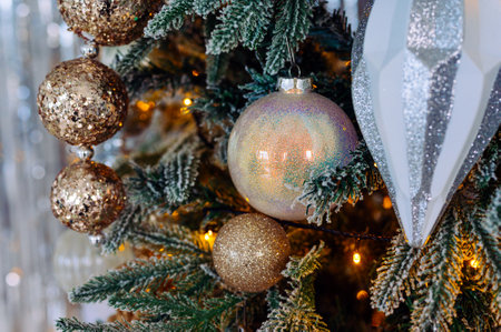 Golden and silver toys on the christmas tree close upの写真素材