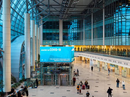 Moscow, Russia - October 9, 2020: Information screen advertising COVID-19 test passing inside Domodedovo airportのeditorial素材