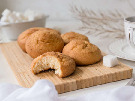bite off a piece of biscuit cookie, a fragment of a still life with pastries, a cup and sugarの写真素材