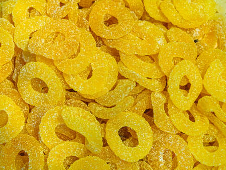 Marmalade Pineapple rings in sugar - food background