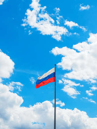 flag of Russia on a background of blue sky with white cloudsの写真素材