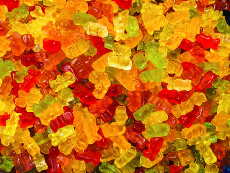 colorful teddy bear shaped sweet gummies - food background