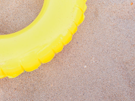 An inflatable rubber circle for swimming lies on the sand. Child safety concept at seaの写真素材