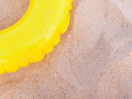 Yellow inflatable ring for swimming on the beach. The concept of children's holiday at the seaの写真素材