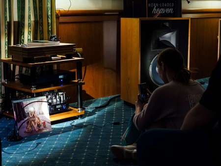 Moscow, Russia - May 23, 2021: Visitors of the HI-FI and HI-END show in the room at the Borodino hotel listen to Madeleine Peyroux's album "Careless Love" on the audio system of KLIPSCH and Manley Chinookのeditorial素材