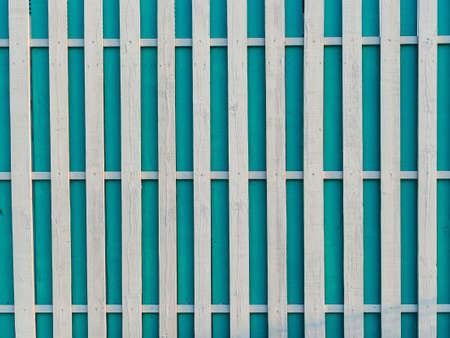 a fence made of white and blue wooden boardsの写真素材