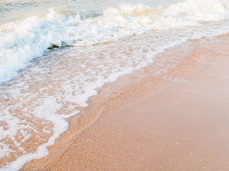 sandy seashore and foamy waveの写真素材