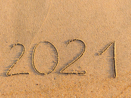 inscription on the sand 2021. The concept of a beach holiday at the seaの写真素材