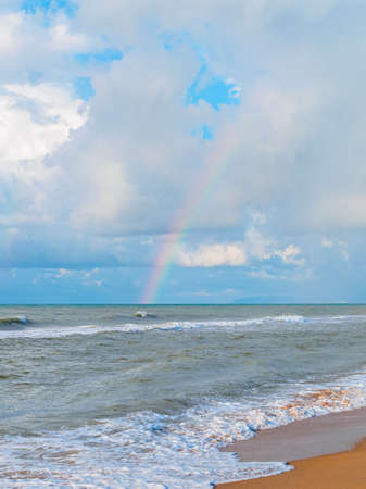rainbow over the sea - view from the beachの写真素材