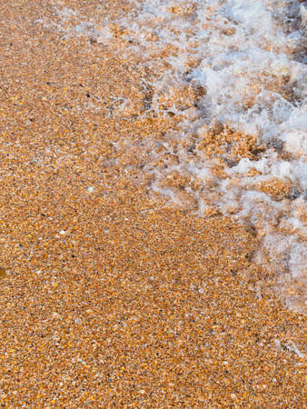 Marine vertical background: close-up of a wave on the beachの写真素材