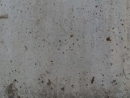 old concrete wall with cracks, scratches and stains closeup - construction elementの写真素材