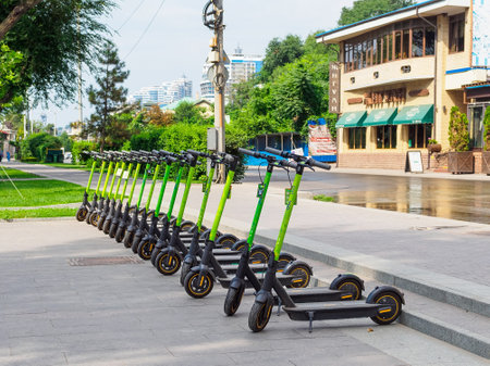 Rostov-on-Don, Russia - August 29, 2021: Electric scooters stand in a row on the sidewalkのeditorial素材
