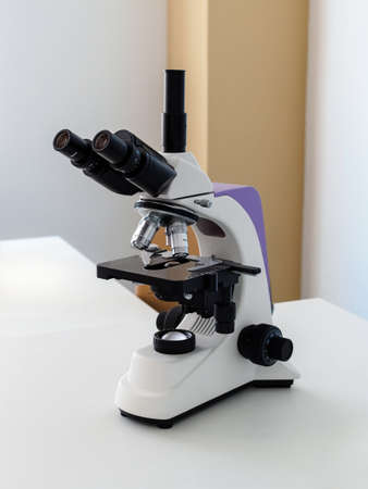 professional microscope on a white table close upの写真素材