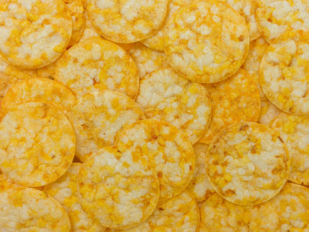many round rice chips with cheese flavor - food backgroundの写真素材