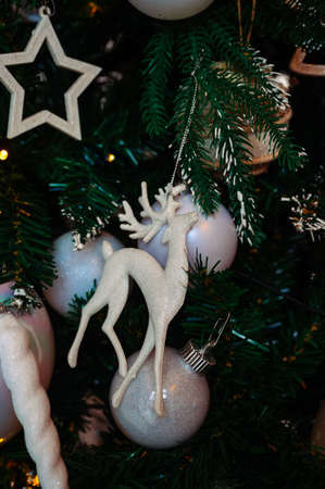 beautiful decoration on a christmas tree in the shape of a white deer close-upの写真素材