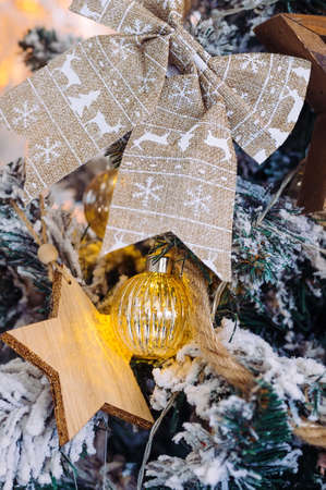 wooden, textile and glass toys on the Christmas tree: bow, star, ball close-upの写真素材