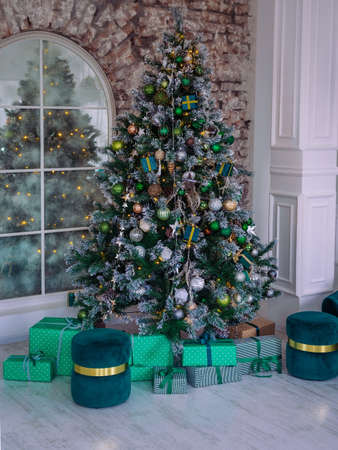 beautiful home christmas tree decorated with toys and garlands, gifts, copy spaceの写真素材