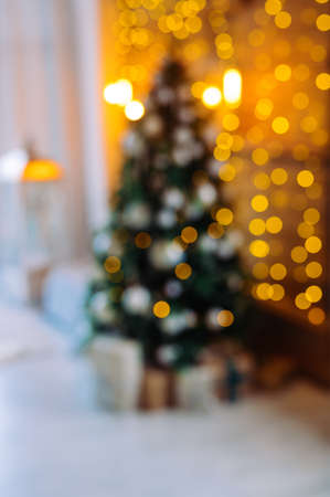 defocused festive background: indoor Christmas tree and beautiful bokeh lightsの写真素材