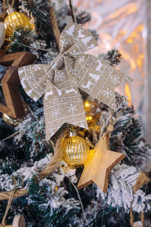 bow, stars, balls and garlands close-up on a christmas tree close-upの写真素材