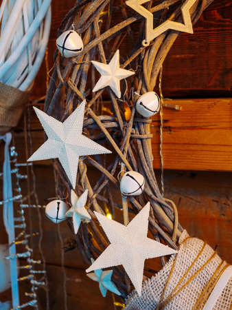 white stars and bells on christmas wreath close upの写真素材