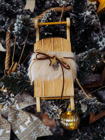 Santa's little sleigh - handmade wooden toy on a Christmas treeの写真素材