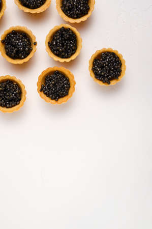 vertical background: tartlets with natural black spicy caviar, copy spaceの写真素材