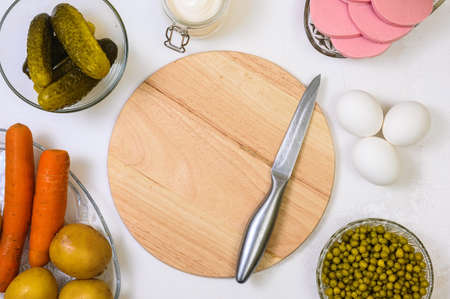 Preparing for Olivier Salad: cutting board, knife and foodの写真素材