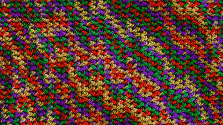 knitted scarf texture. Wool threads of green, purple, yellow, redの写真素材