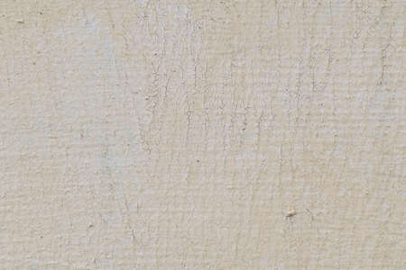 beige old paint on the wall with small cracksの写真素材