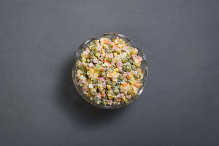 russian festive salad olivier in vintage crystal bowl on gray backgroundの写真素材