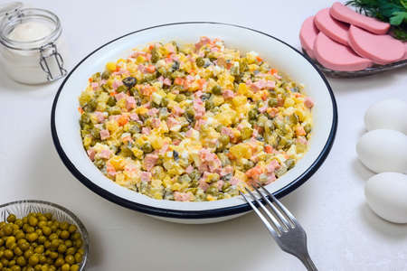 Russian Olivier in a large salad bowl on white backgroundの写真素材