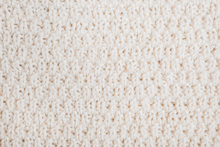 woolen background: hand-knitted sweater with thick thread close-up