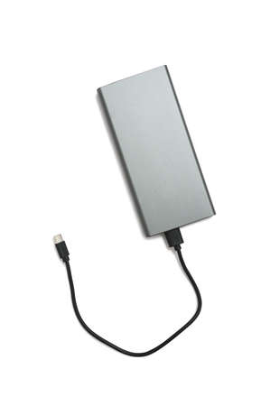 Universal external battery - powerbank in a metal case and a USB cable, isolated on white with a...