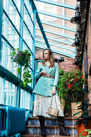 attractive slim young woman posing on stairs stepsの写真素材